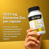 Close-up of a hand holding Naturmade Zinc Immune Renu capsules bottle with product dosage information
